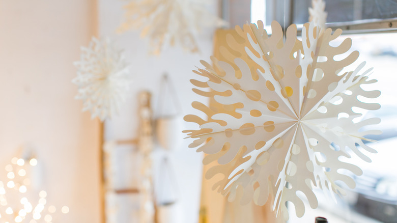 White paper snowflakes hanging from the ceiling