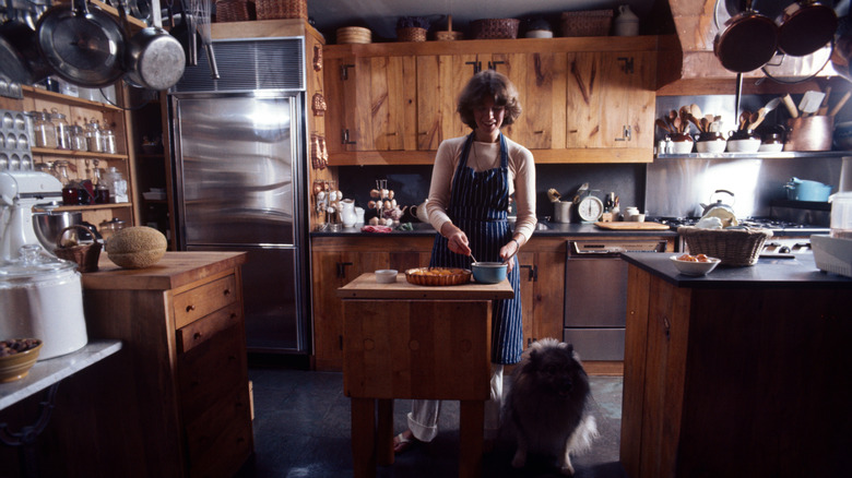 Martha stewart working at freestanding wood island in kitchen