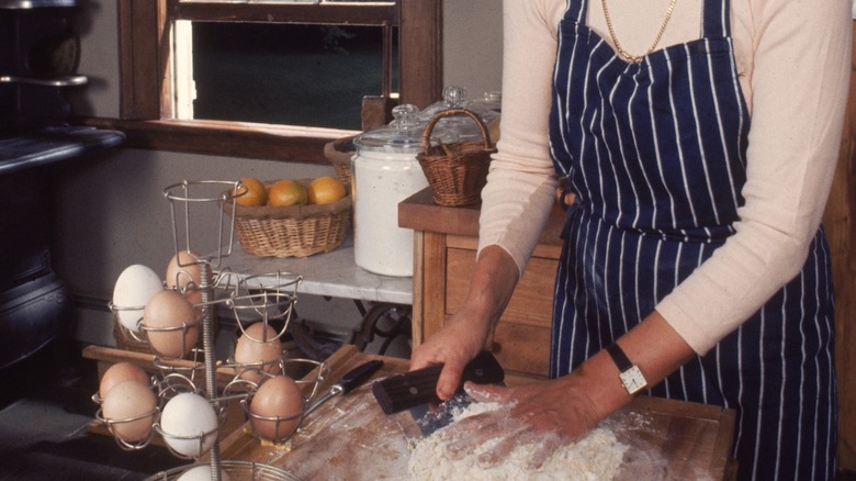 Martha Stewart working with dough in rustic kitchen