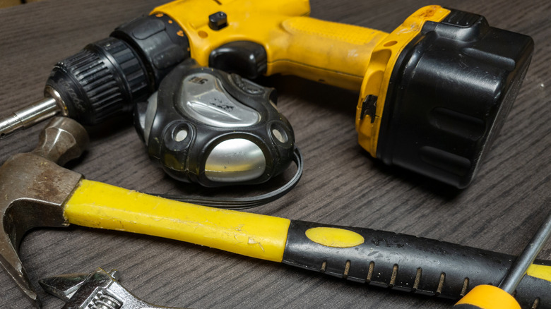 A variety of hand and power tools in black and yellow