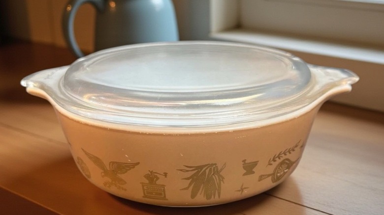 Brown casserole dish with Early American pattern