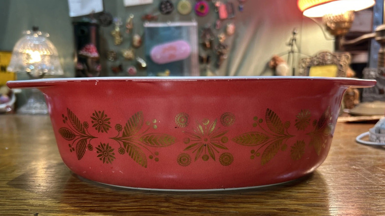 A gold on red Pyrex casserole dish known as Golden Poinsettia