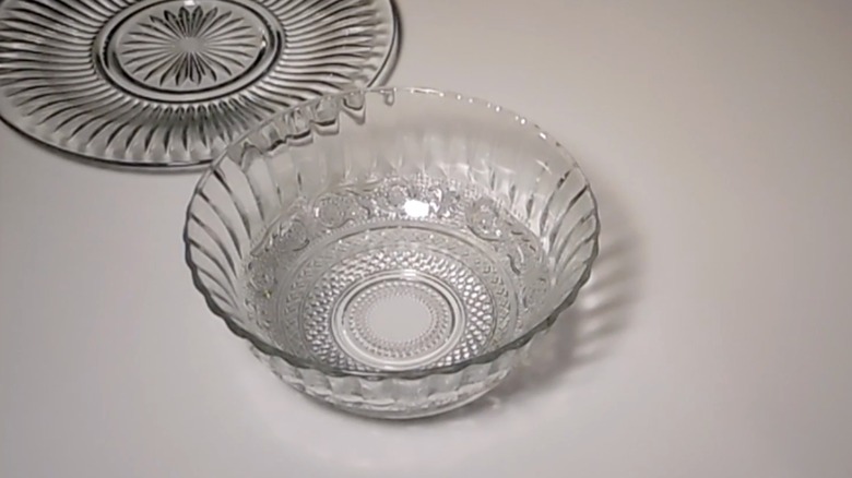 Screenshot of a YouTube video, showing an empty glass bowl from Dollar Tree next to a glass tray.