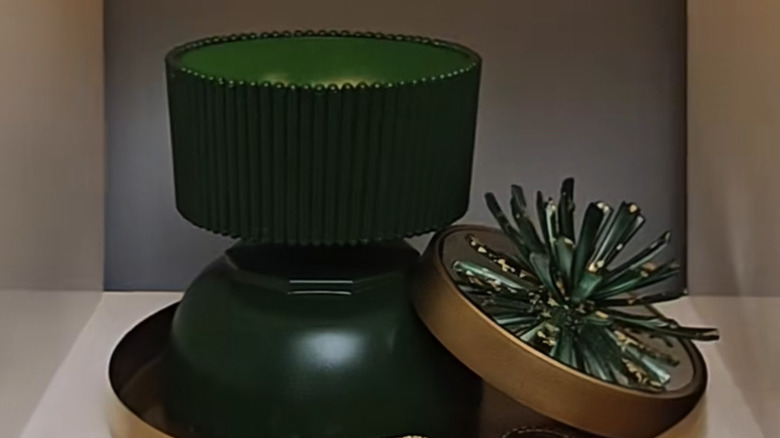 Green painted decorative bowl with gold and green decorative accent on a tray