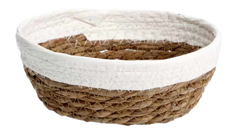 a brown and white woven Dollar Tree basket set against a white background.
