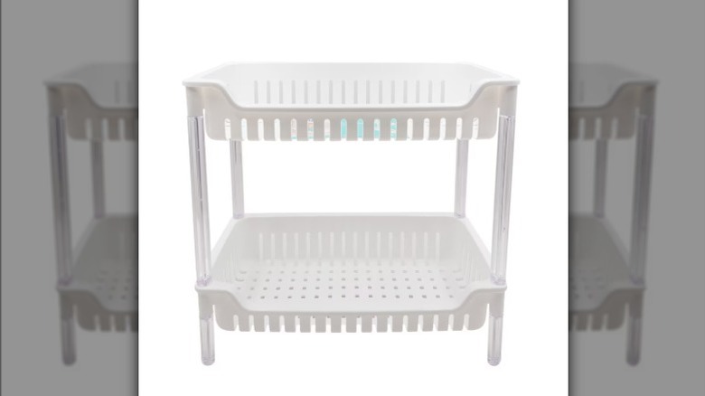 Screenshot of an instagram reel showing a Dollar Tree shelving rack used to store dish cloths and supplies.