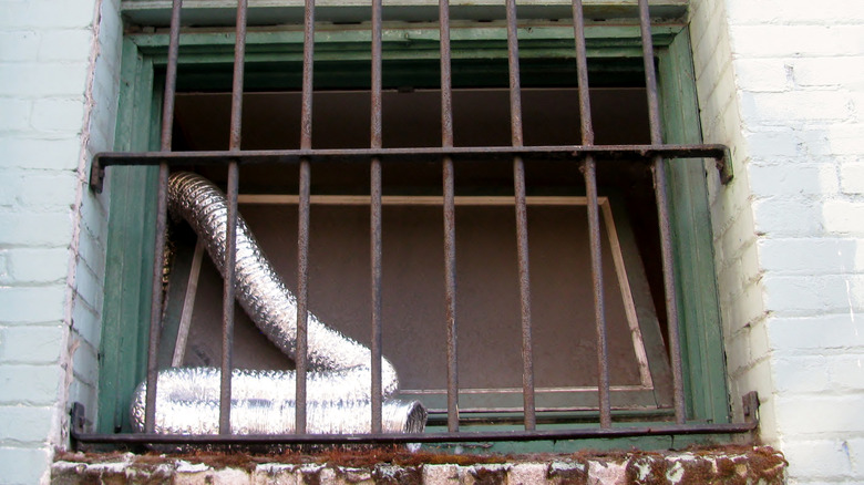 A burglar wearing a mask inside of a home