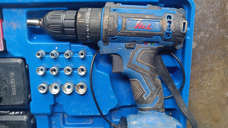 Dirty drill with dusty vents in blue storage case