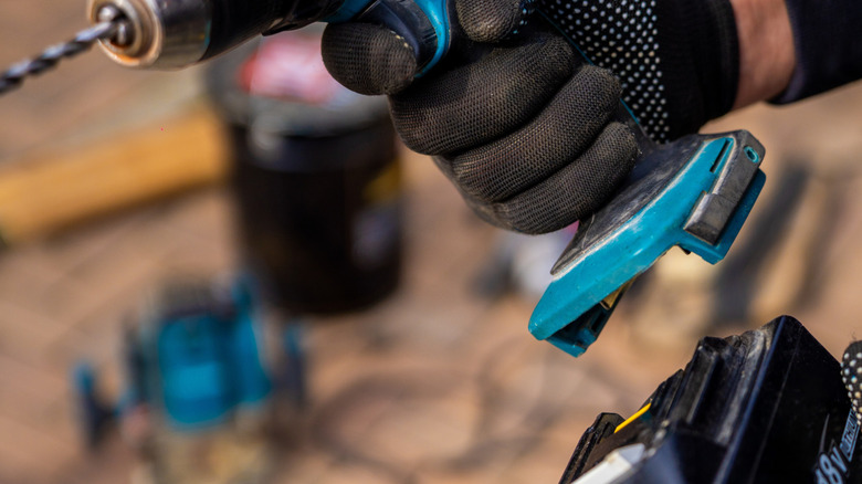 Person removing drill battery