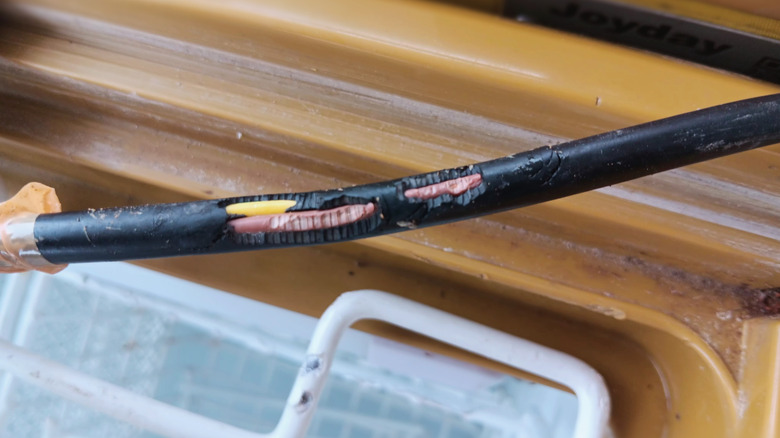 Damaged electrical cable with wires exposed