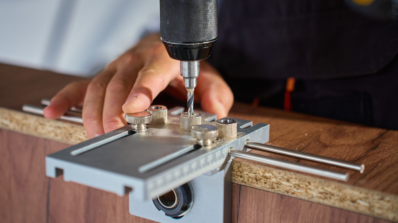 Person drilling into metal