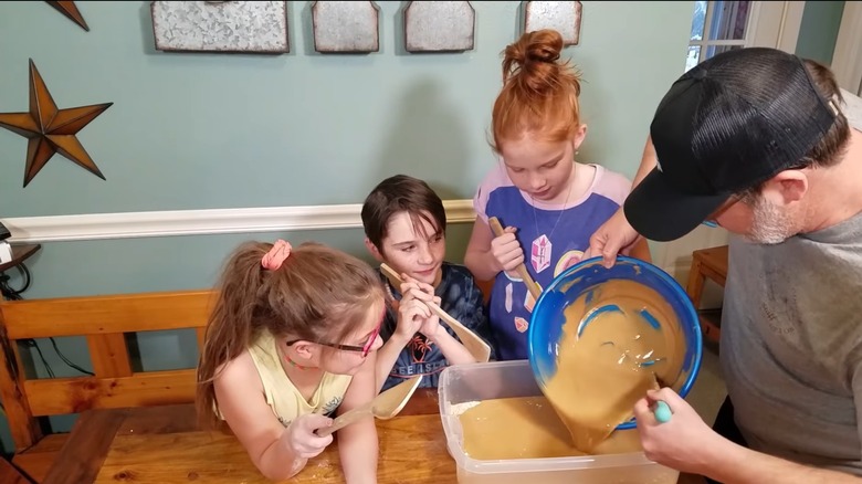 Man along with his kids making Zick dough