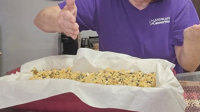 Woman standing behind a batch of no-melt suet cakes