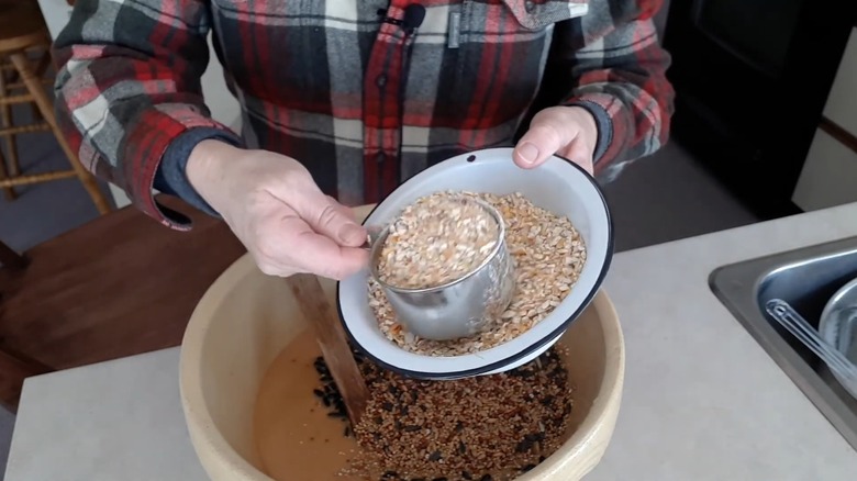 Woman mixing in seeds to create a dry fruit suet