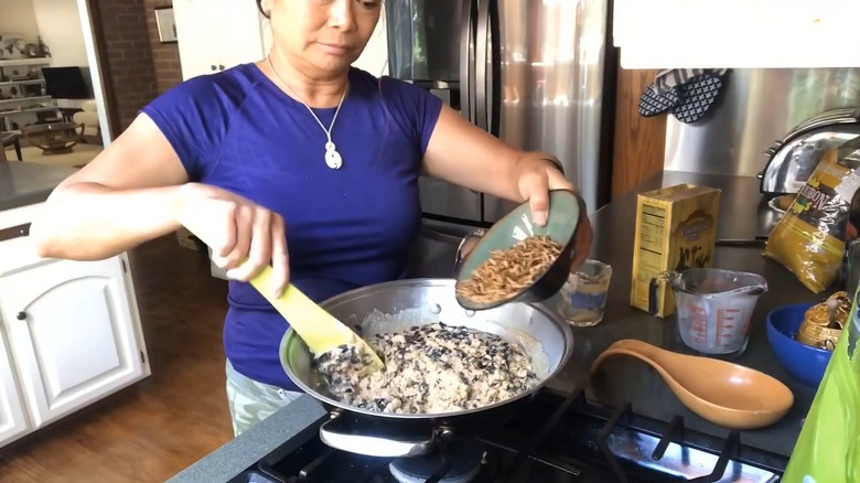 Woman mixing in meal worms in a suet recipe