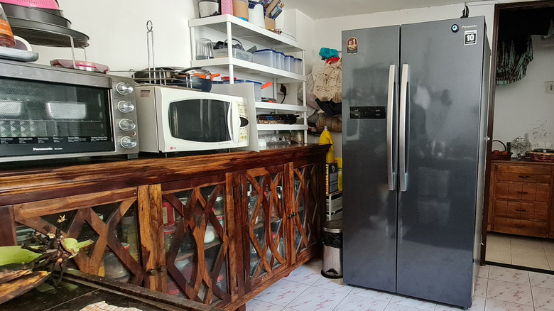 A refrigerator with side by side doors in kitchen.