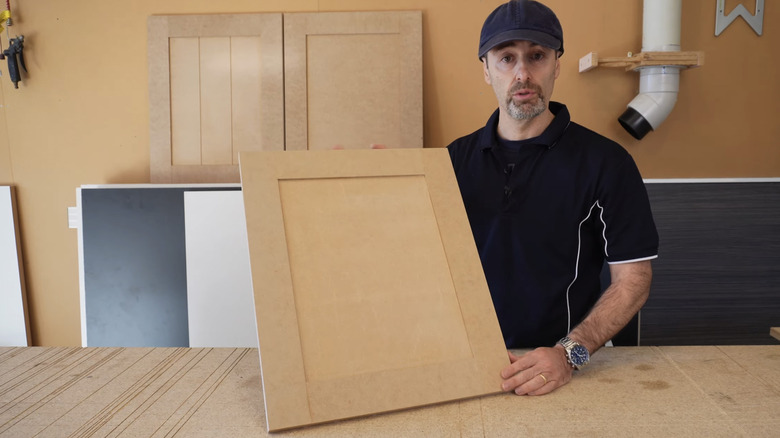 Man in hat showcasing DIY shaker cabinet