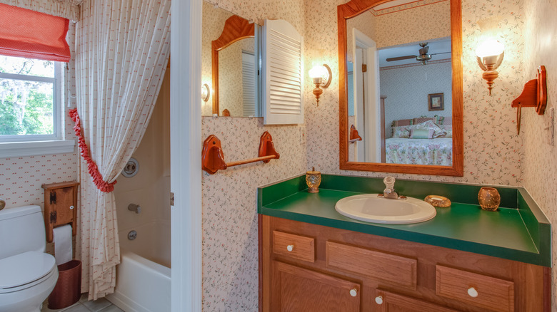 Outdated bathroom with old wooden countertops