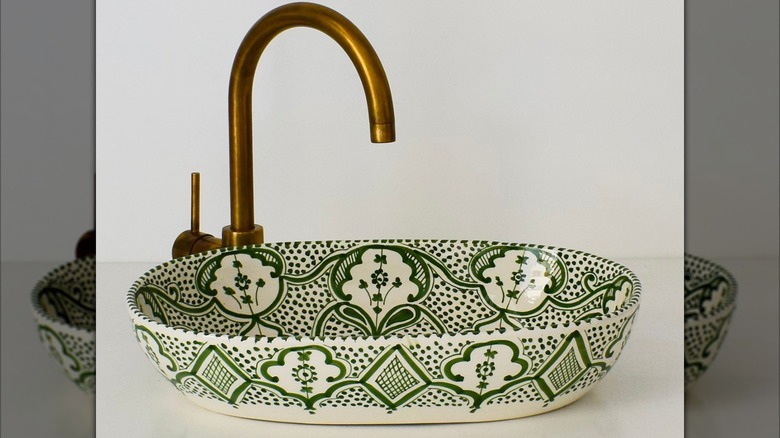 Green ceramic vessel sink with gold faucet
