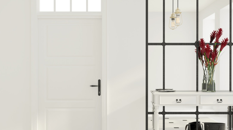 Bright entryway with a full-length mirror behind a table