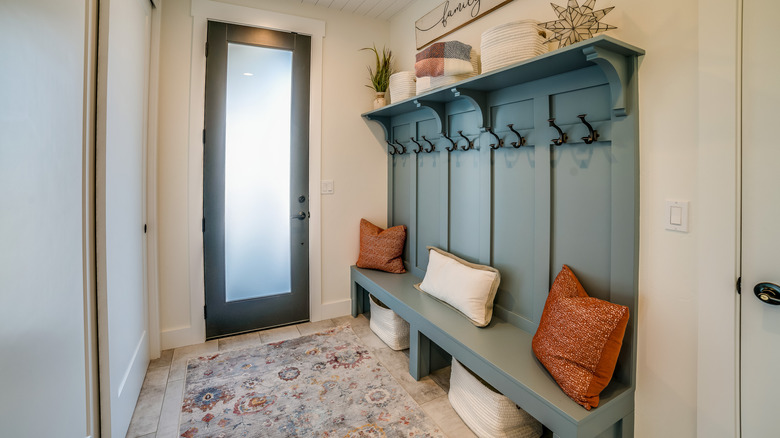 Entryway with green built-in bench