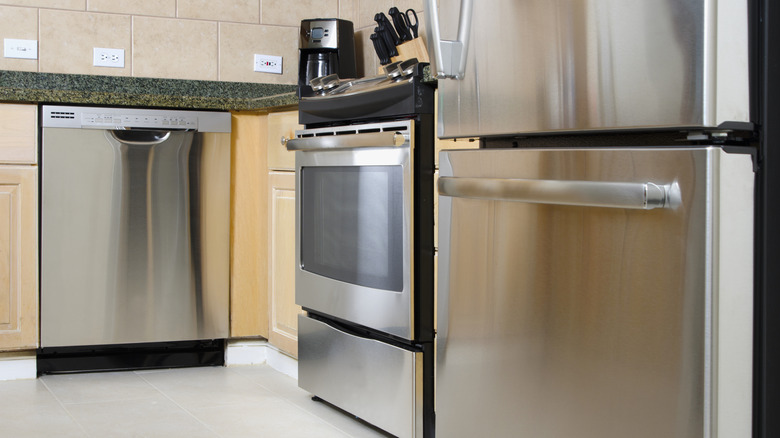 Stainless steel dishwasher, oven, and fridge-freezer