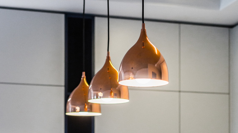 Copper pendant lights hanging in kitchen