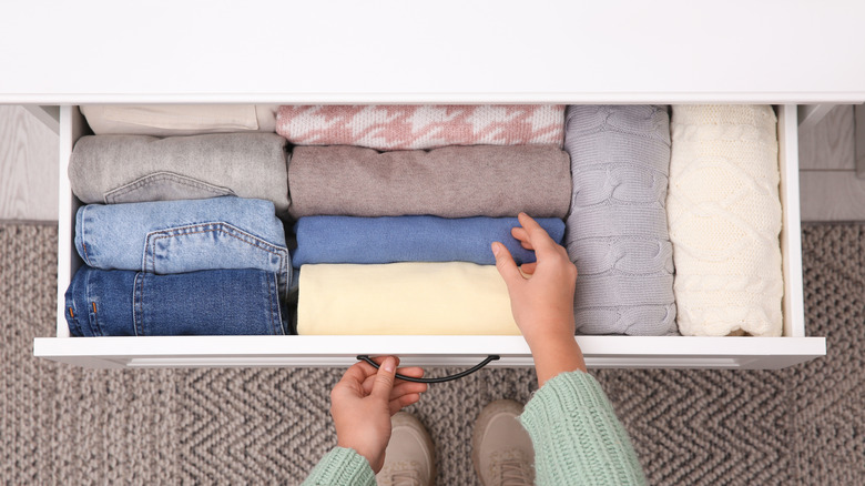 sweaters folded vertically in a drawer