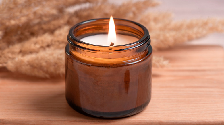 candle burning inside a glass jar