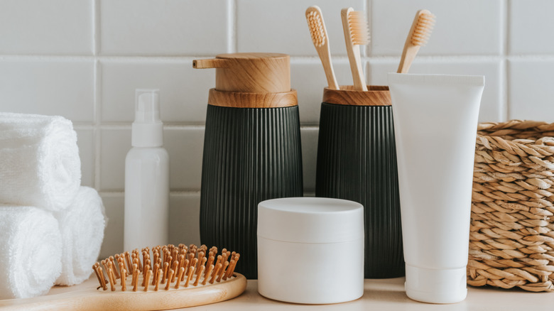 hairbrush, towels, and other bathroom essentials sitting on counter