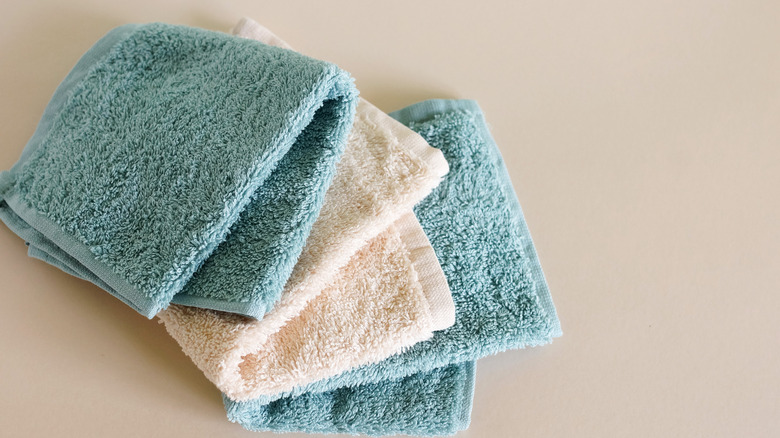 A small stack of blue and white wash cloths.