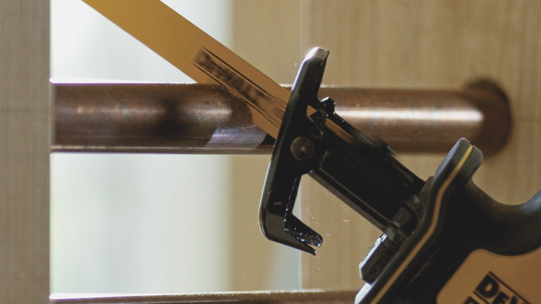 DeWalt Reciprocating saw from the Cordless Combo Kit being used to cut copper pipe
