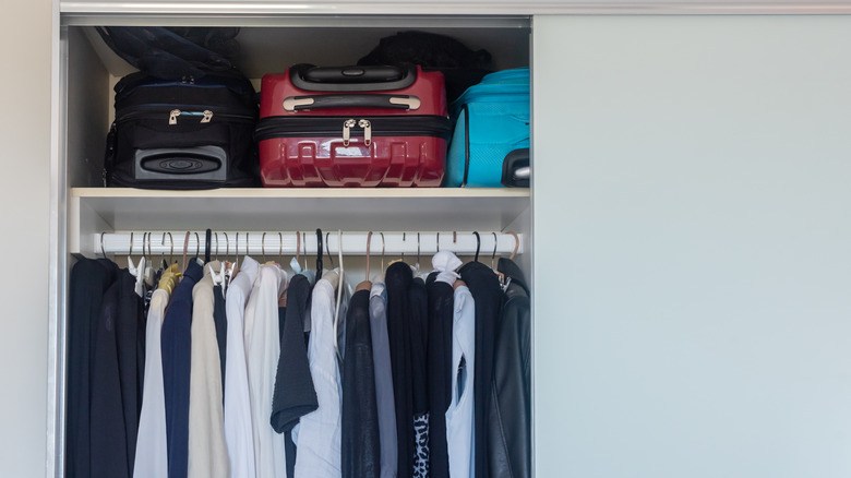 Suitcases in the top of a closet