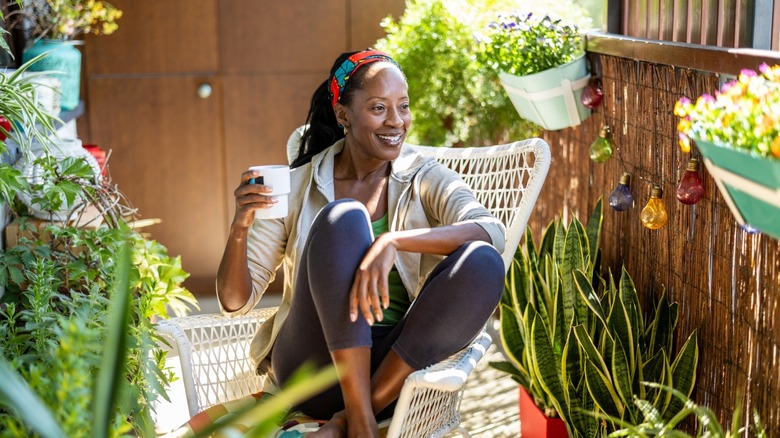 A woman enjoying a drink on an outdoor patio