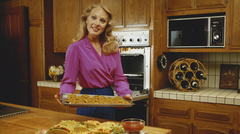 Woman cooking in 1980's kitchen