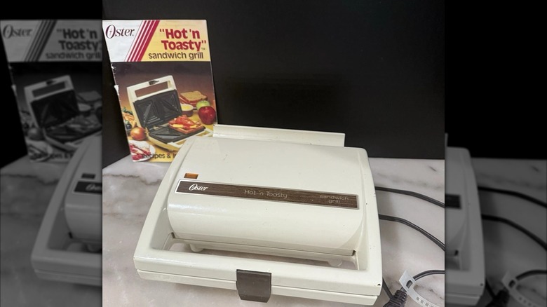 Oster Hot 'N Toasty sandwich grill with instruction booklet