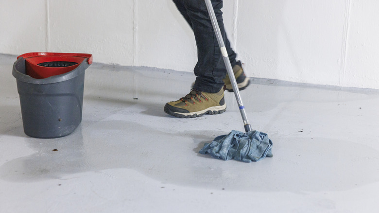 Close-up of a person mopping up a spillage