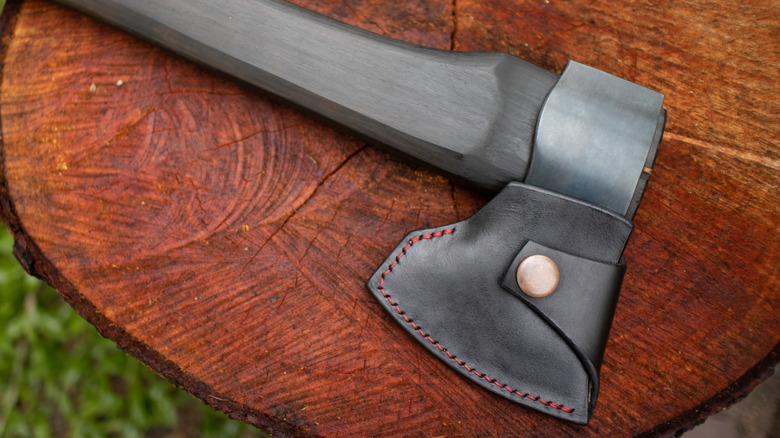 An axe with a leather sheath to protect the blade