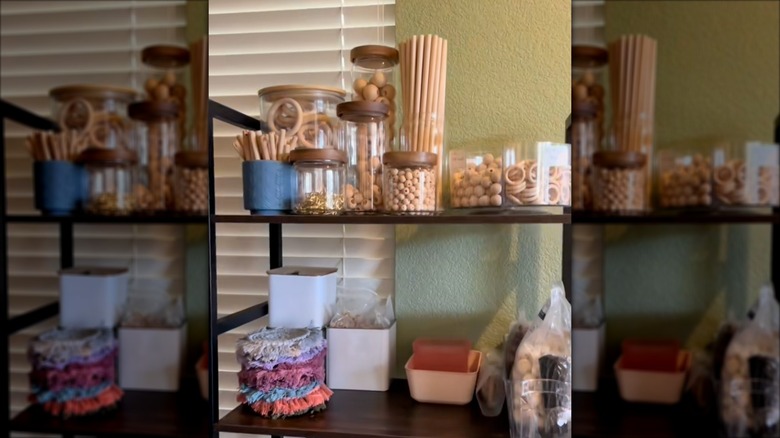 Craft supplies are displayed on a metal shelf