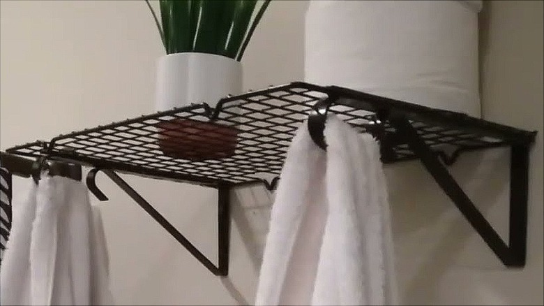 Black plant bracket shelf made with cooling rack hanging towels