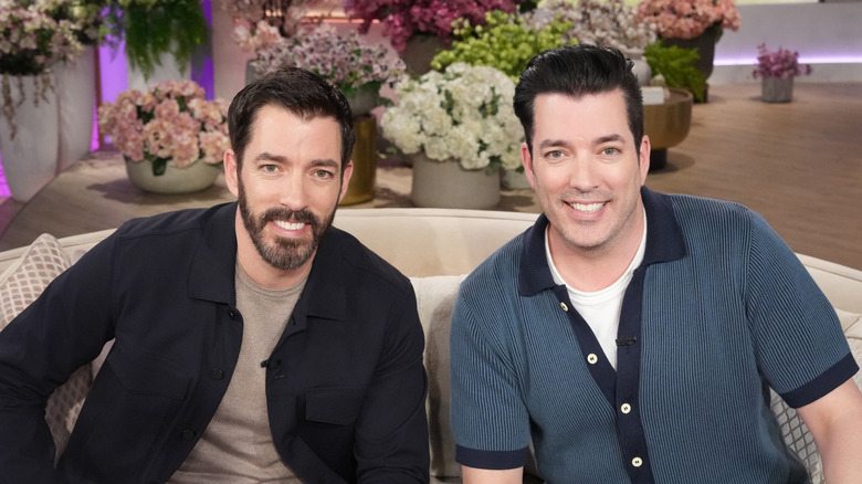 The Property Brothers in front of flowers