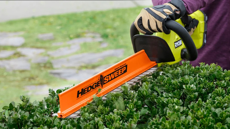 Close-up of Ryobi's 18V One+ 22-inch Cordless Hedge Trimmer at work