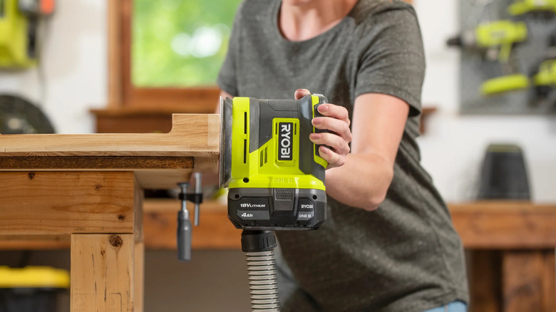A person sanding wood with Ryobi's 18V One+ 5-inch Random Orbit Sander