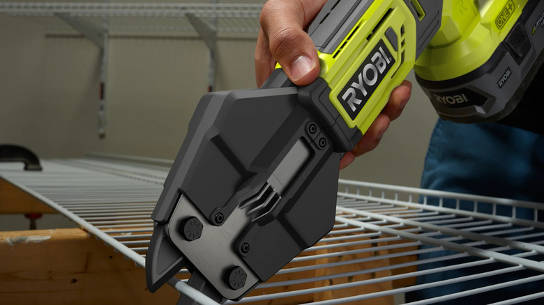 A person using Ryobi's 18V One+ Cordless Bolt Cutters to cut wire shelves