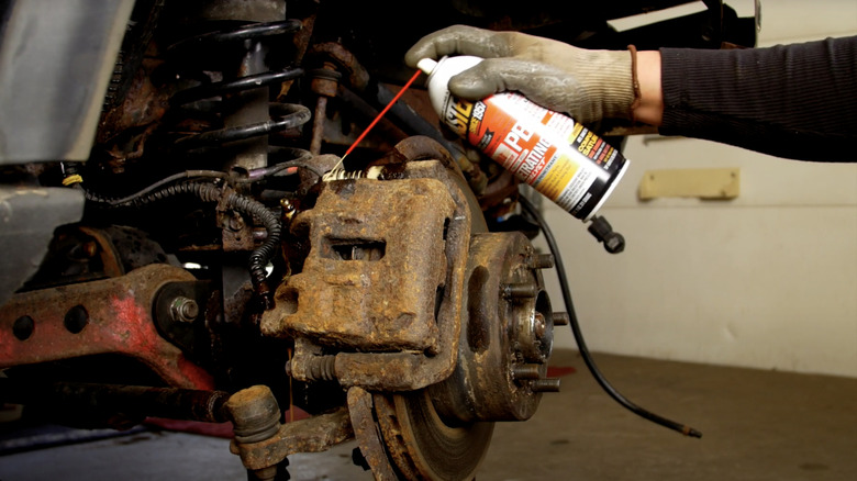 PB B'laster being used on rusted car parts