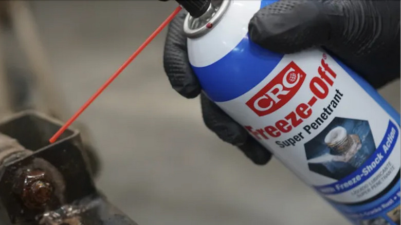 A can of CRC Industries' Freeze-Off Super Penetrant being used on a rusty bolt