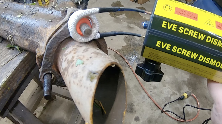 An induction heater in use to loosen a rusted bolt