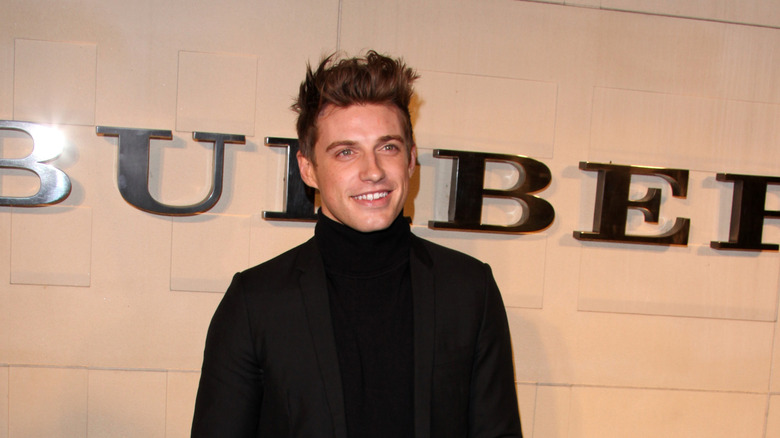 Jeremiah Brent smiling in a black suit.