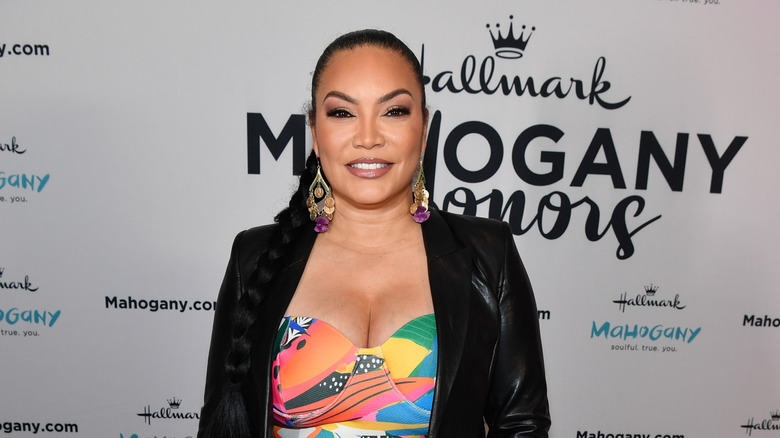 Egypt Sherrod smiling in a colorful dress and blazer.