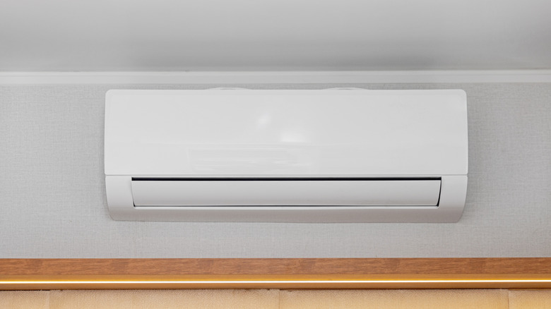 A mini split air conditioner on a white wall